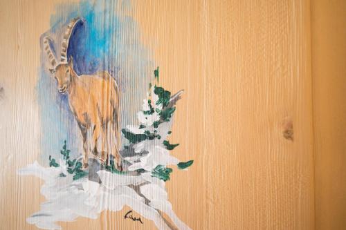 a painting of a goat on a wall at Hotel Sogni D'Oro in Camporosso in Valcanale