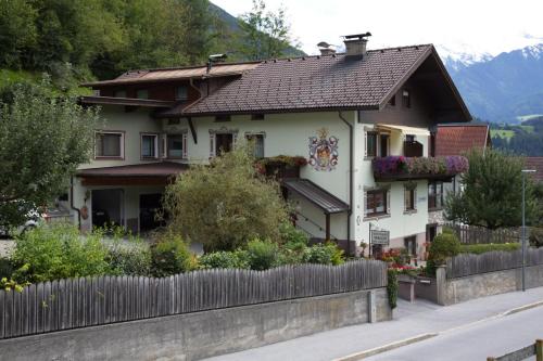 a house with a fence in front of it at Gästehaus Walch-Riml in Imst