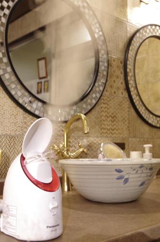 a bathroom with a sink and a hair dryer on a counter at Ryoso Chatani in Kyoto