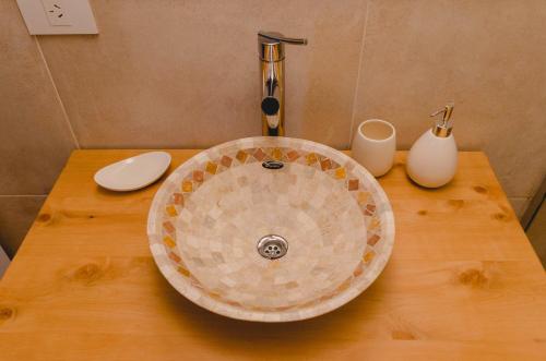 a bathroom sink sitting on a wooden table at ALEHUE Casa de Montaña in Villa La Angostura