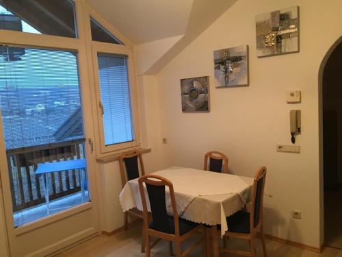 a table and chairs in a room with a window at Lochererhof in Appiano sulla Strada del Vino