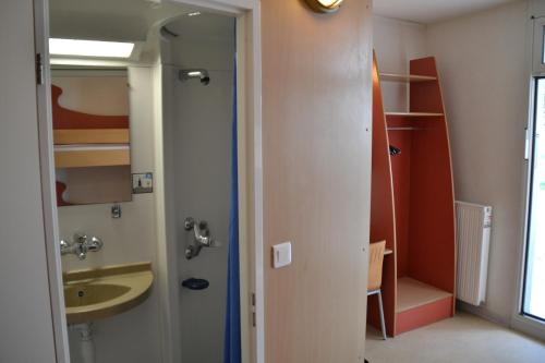 a bathroom with a sink and a mirror at Auberge de Jeunesse in La Rochelle
