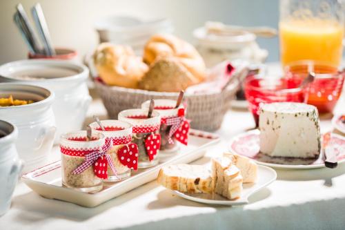 a table topped with plates of bread and pastries at Hotel-Pension Faneskla in Silbertal