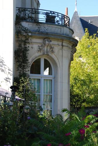 a building with a window and a balcony on it at La Gourmandine in Châtellerault