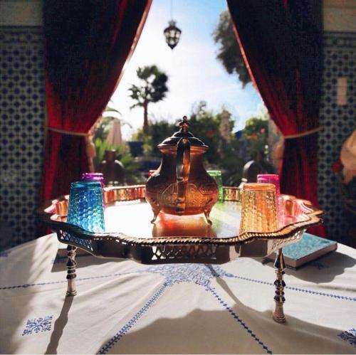 a vase sitting on a table with candles on it at Riad Jean Claude in Fez