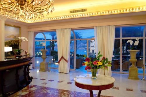 a living room with a table with flowers on it at Hotel Continental in Sorrento