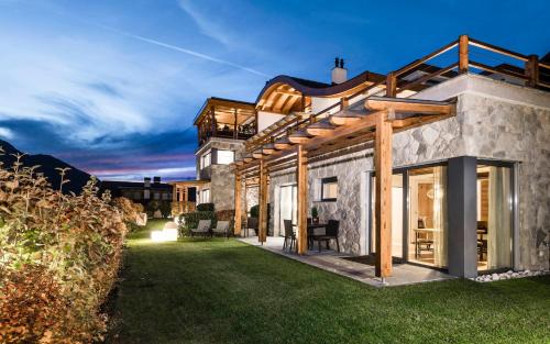 a house with a view of the yard at Apartments Chalet Anna in Ortisei