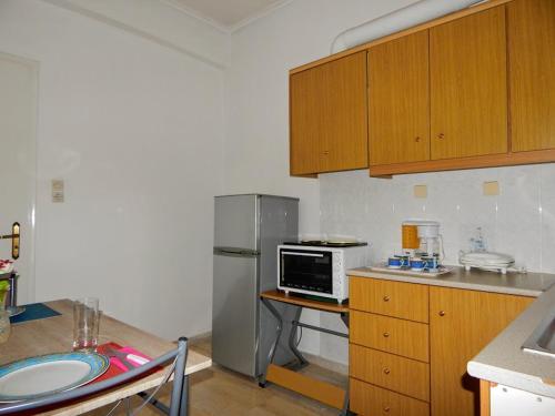 a kitchen with a stainless steel refrigerator and a microwave at Cozy apartment for 2-5 people-Center Tripoli in Tripoli