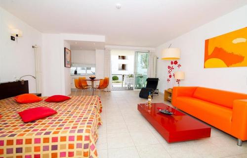 a living room with a bed and a couch at Excellent Golden Apartment in Cabanas de Tavira