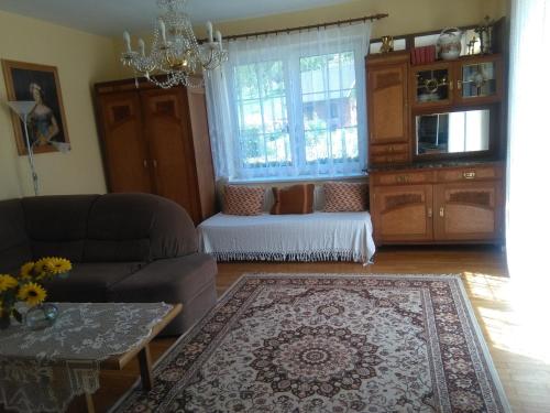a living room with a couch and a window at Vila Patricie in Luhačovice