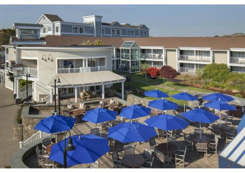 a bunch of blue umbrellas in front of a building at Hyannis Harbor Hotel in Hyannis