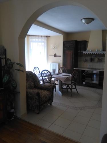 an open living room with a table and chairs at Vila Patricie in Luhačovice