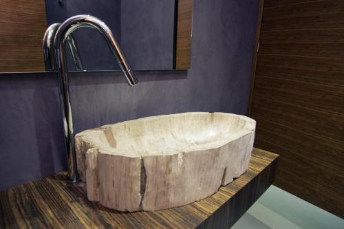 a wooden bath tub with a faucet in a bathroom at Hotel Restaurante Masía la Torre in Mora de Rubielos