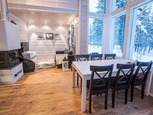 a living room with a dining room table and chairs at Holiday Home Oppas lapland levi by Interhome in Levi
