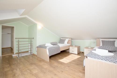 a small room with two beds and a staircase at Luxury apartments Kostrena with pool in Kostrena