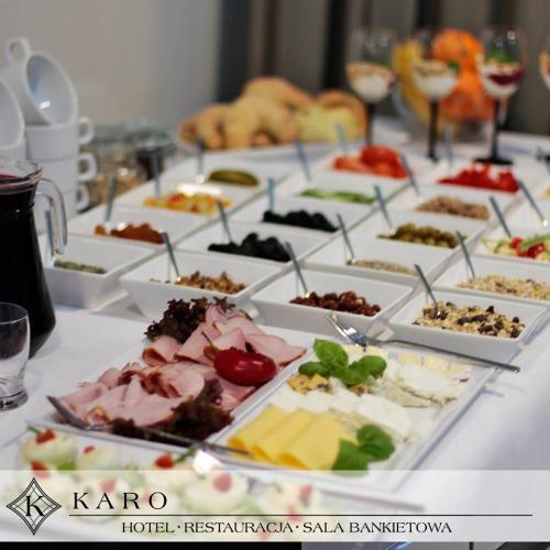 a table with many different types of food on it at Hotel KARO in Radom