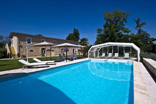 a large swimming pool with a gazebo at Chateau Pontet d'Eyrans & Spa in Eyrans-de Soudiac