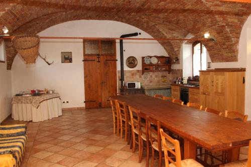 a kitchen and dining room with a wooden table and chairs at Casa Giovannella in Feltre