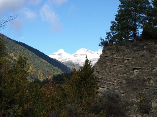 a mountain with snow capped mountains in the background at El Churrón in Larrés