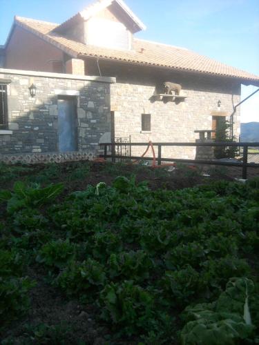 a stone house with a goat on top of it at El Churrón in Larrés