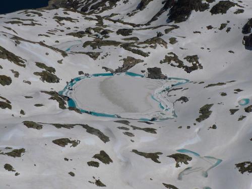 a snow covered mountain with a river in it at El Churrón in Larrés