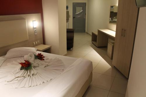 a bedroom with a white bed with flowers on it at La caretta in Alikanas