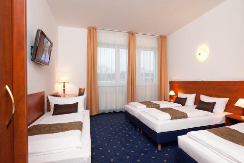 En eller flere senge i et værelse på Hotel Atrium Charlottenburg