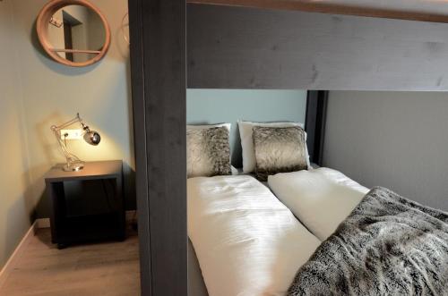 a loft bed with two pillows in a bedroom at Kappeberg Lodge in Winterberg