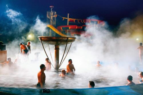 a group of people in the water at a water park at Wellness Hotel Bešeňová in Bešeňová