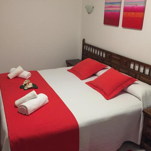 a bedroom with two beds with red and white towels at Hotel Florida in A Lanzada