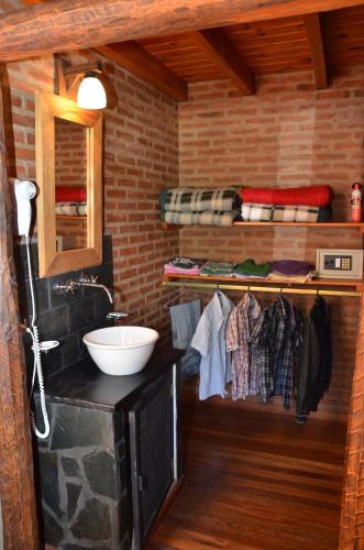 a bathroom with a sink and a counter with towels at Lauquen Pilmaiquen y spa in Merlo