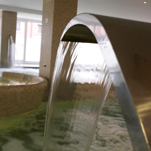 a water fountain in a bathroom with a sink at Hotel Bienestar Moaña in Moaña