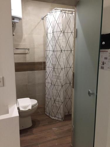 a bathroom with a toilet and a shower at Buccaneers Boutique Guest House in St Paul's Bay