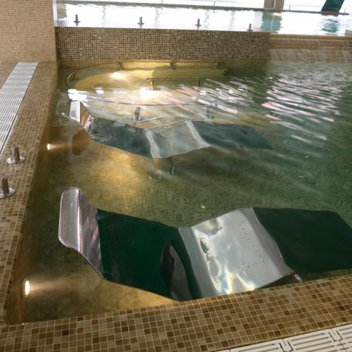a large pool of water with a slide in it at Hotel Bienestar Moaña in Moaña