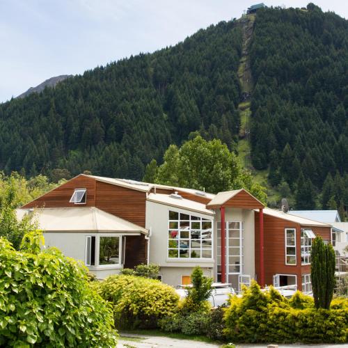 a house with a mountain in the background at Haka House Queenstown in Queenstown