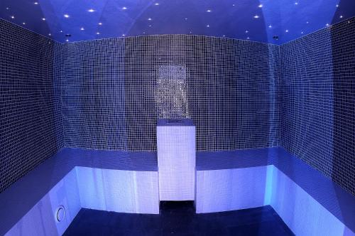 a bath tub in a room with blue tiles at Hotel Kandahar in Pas de la Casa