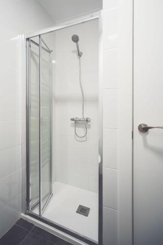 a shower with a glass door in a bathroom at Casual Serantes Bilbao in Bilbao