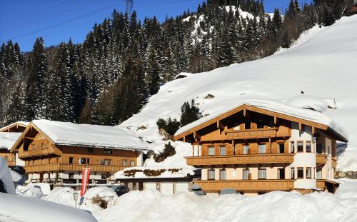 a large wooden building covered in snow at Landhaus Staudacher in Gerlos