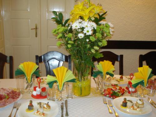 a table with a vase of flowers on top of it at Pension Hotel Fast in Rădăuţi
