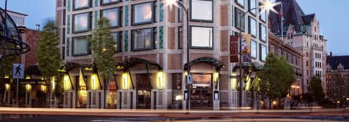 a tall building on a city street at night at The Magnolia Hotel & Spa in Victoria