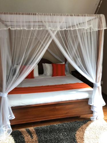 a bed with a canopy in a room at Dorchester in Nuwara Eliya