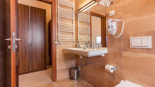 a bathroom with a sink and a mirror at Hotel Maroon in Zagreb