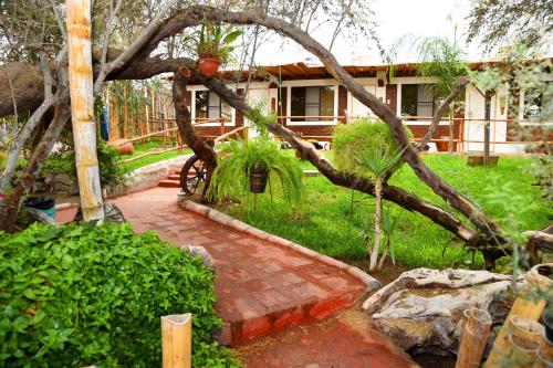 a garden with a brick walkway in front of a house at Rochabus in Ica