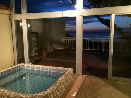 a swimming pool with a view of the ocean at Wood Pecker Nakijin in Nakijin
