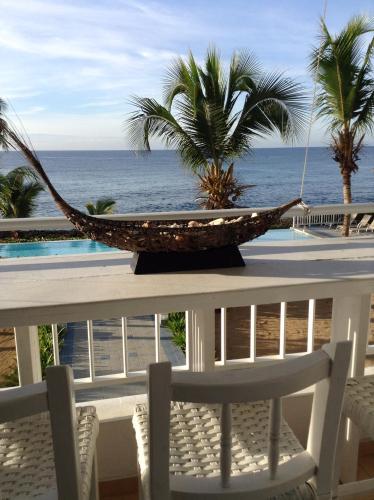 a hammock on a table with a view of the ocean at Apartamento Juan Dolio in Juan Dolio