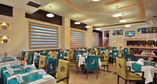 a dining room with tables and chairs in a restaurant at Best Western Maryland in Chandīgarh