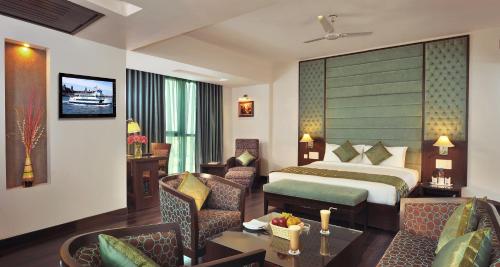 a hotel room with a bed and a table and chairs at Best Western Maryland in Chandīgarh