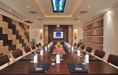 a conference room with a long table and chairs at Best Western Maryland in Chandīgarh