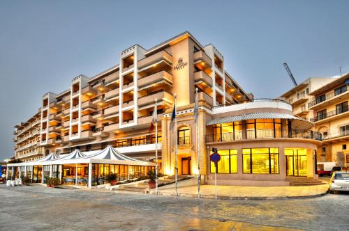 a large building with a tent in front of it at Hotel Calypso in Marsalforn