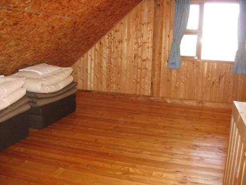 a room with two bunk beds and a window at Log Cottage Himawari in Nakafurano